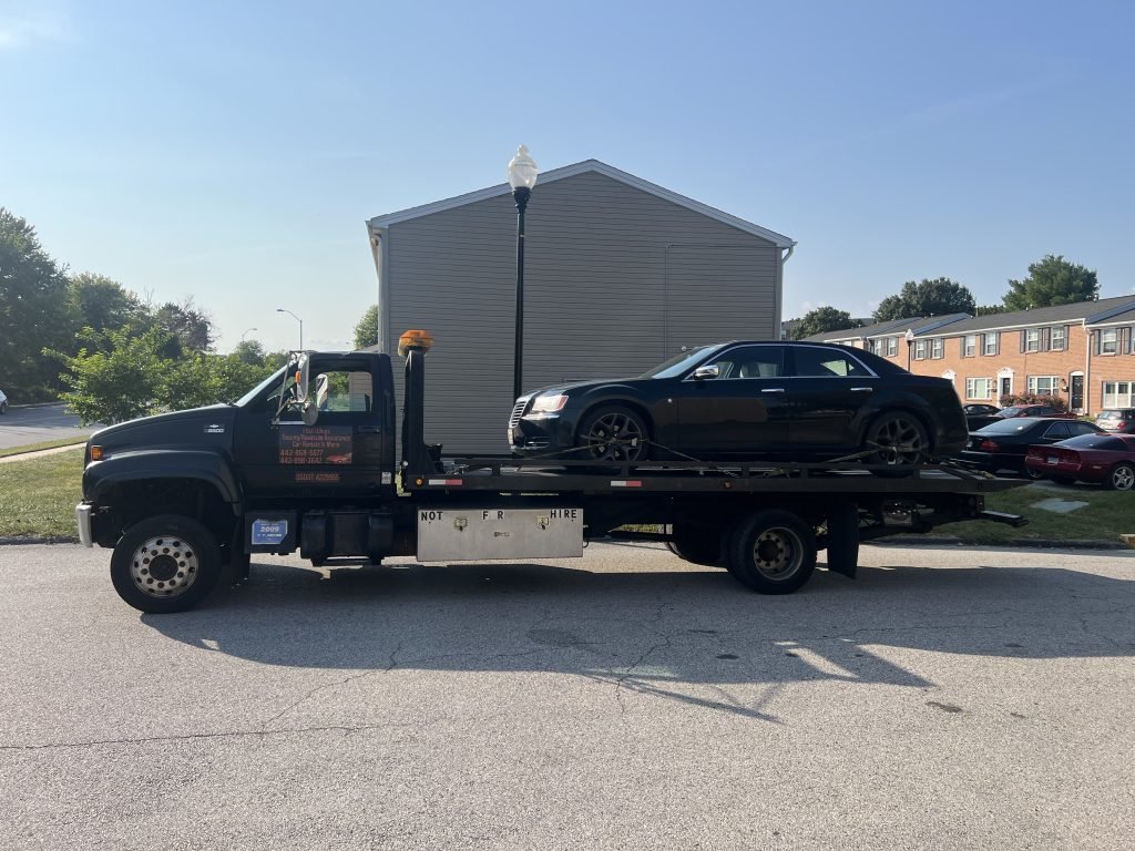 I got Whipz Towing & Roadside Assistance with a black Chrysler 300 towing near me from 2 Shadwell ct Windsor Mill, MD 21244 to 908 Reece Rd Severn, MD 21144