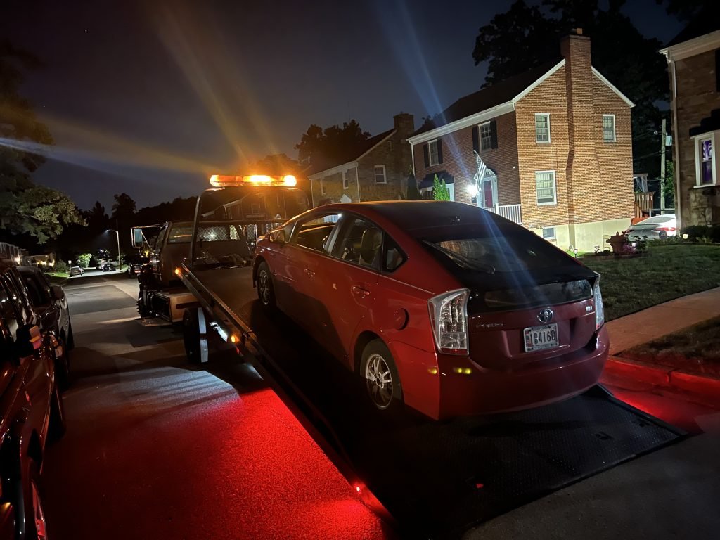 I got Whipz Towing & Roadside Assistance with a red Toyota Prius towing near me from 695 W Pikesville, MD 21208 to 3600 Oak Ave Lochearn, MD 21207