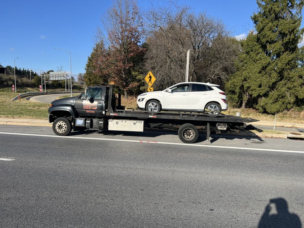 I got Whipz Towing & Roadside Assistance with a white hybrid ev towing near me from 1600 whitehead ct woodlawn, MD 21207 to 2200 Rolling rd Baltimore, MD 21244