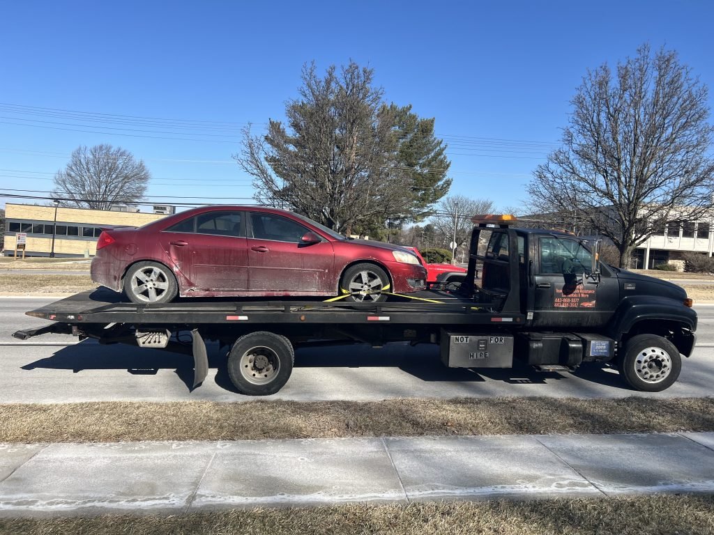 I got Whipz Towing & Roadside Assistance with a red pontiac g5 towing near me from 6400 Security Blvd to 300 stone croft rd Baltimore, MD 21229
