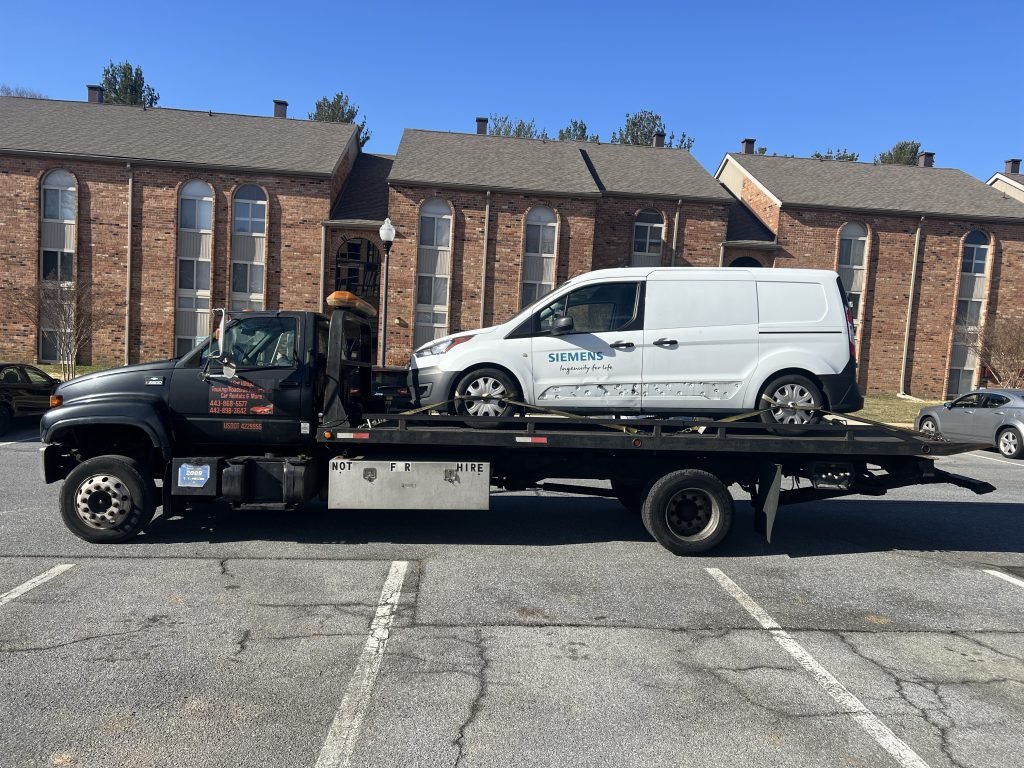 I got Whipz Towing & Roadside Assistance with a white ford transit towing near me from 7418 Lesada Dr Windsor Mill, MD 21244 to Beltsville, MD 20704