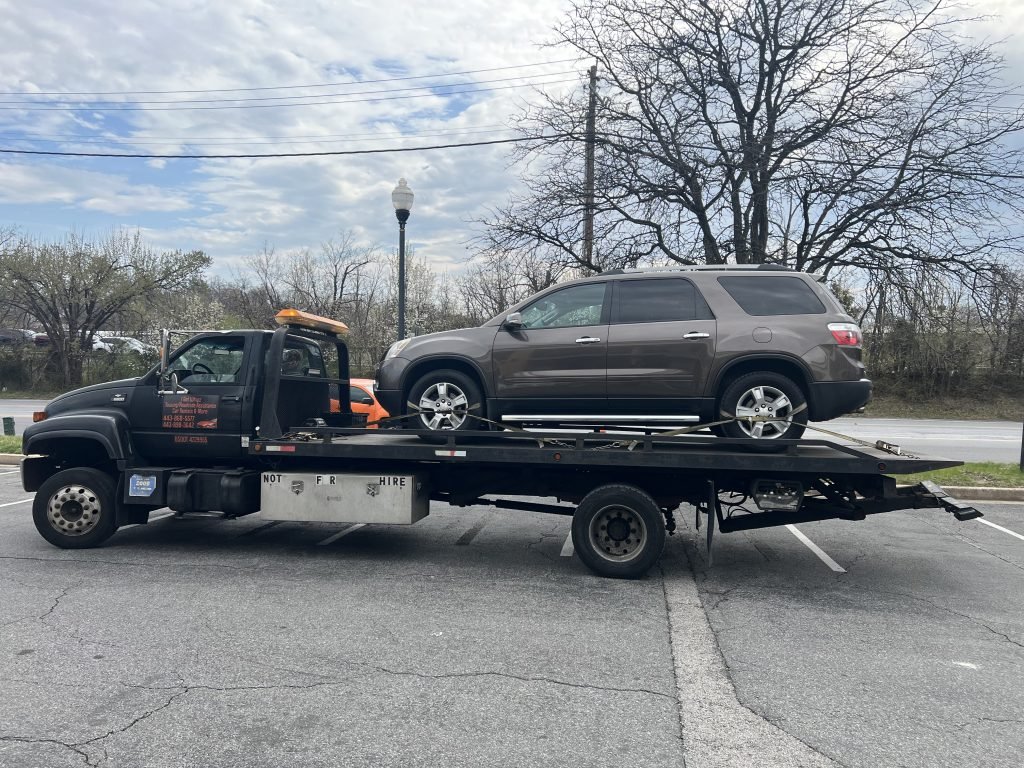 I got Whipz Towing & Roadside Assistance with a brown Gmc Acadia towing near me from 6817 Dogwood rd Woodlawn, MD 21244 to 220 Collins ave Baltimore, MD 21229