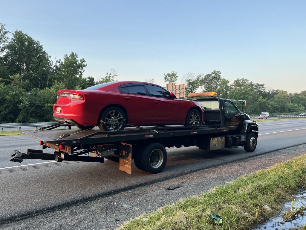 I got Whipz Towing & Roadside Assistance with a red dodge charger sedan towing near me from 39.201353, -76.760401 to 5510 Northgreen Rd, Windsor Mill, MD 21244