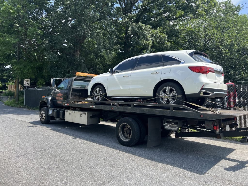 I got Whipz Towing & Roadside Assistance with a white acura mdx suv towing near me from 600 S camp Meade rd, Linthicum Heights, MD 21090 to 9440 Paragon Court, Owings Mills,MD 21117