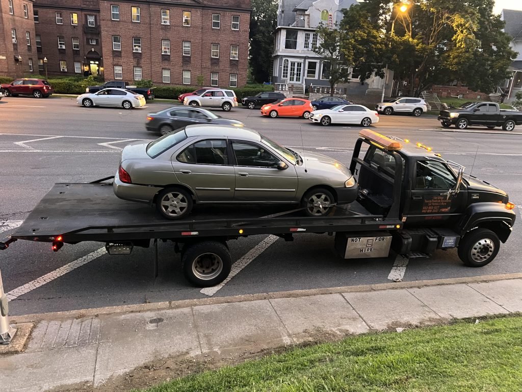 I Got Whipz Towing & Roadside Assistance with a grey Nissan sentra sedan towing near me from 807 S Sharp St Baltimore,MD 21230 to 3599 Mcculloh St Baltimore,MD 21217