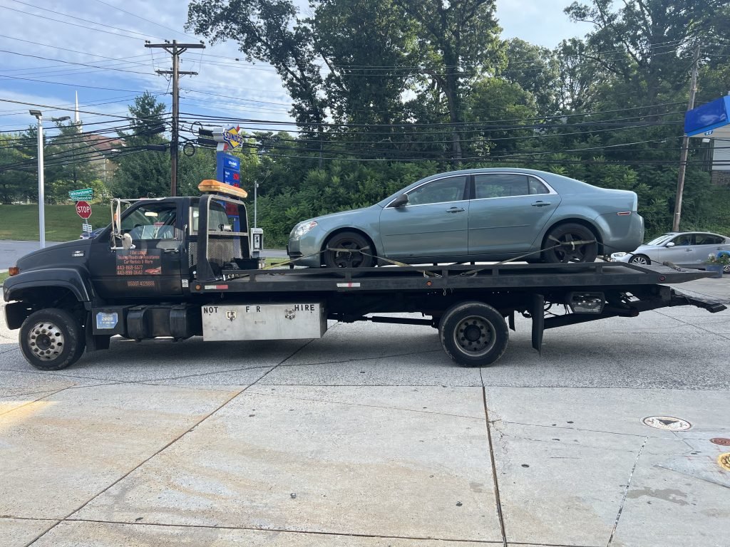I Got Whipz Towing & Roadside Assistance with a blue chevy impala sedan towing near me from 6725 Dogwood Rd, Baltimore, MD 21207 to 2215 N Monroe St, Baltimore, MD 21217