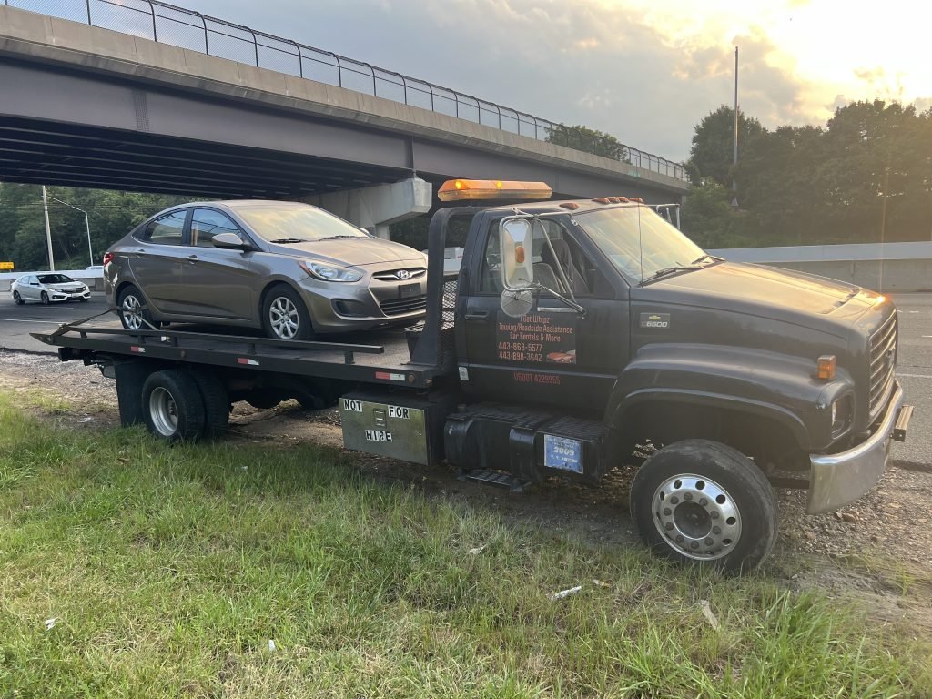 I Got Whipz Towing & Roadside Assistance with a gold hyundai elantra sedan towing near me from 39.368116, -76.748120 to 5200 Patrick Henry Dr Brooklyn Park, MD 21225