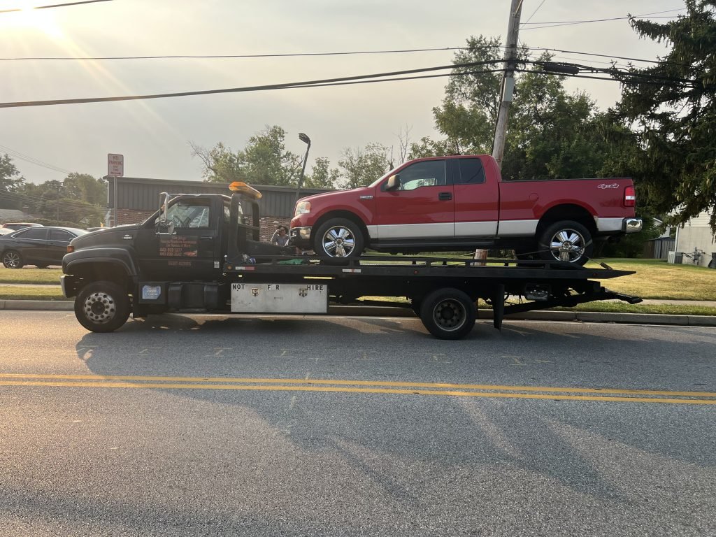 I Got Whipz Towing & Roadside Assistance with a red Ford F-150 truck towing near me from 2043 Featherbed Ln Baltimore, MD 21207 to 3916 Carthage Rd, Randallstown, MD 21133