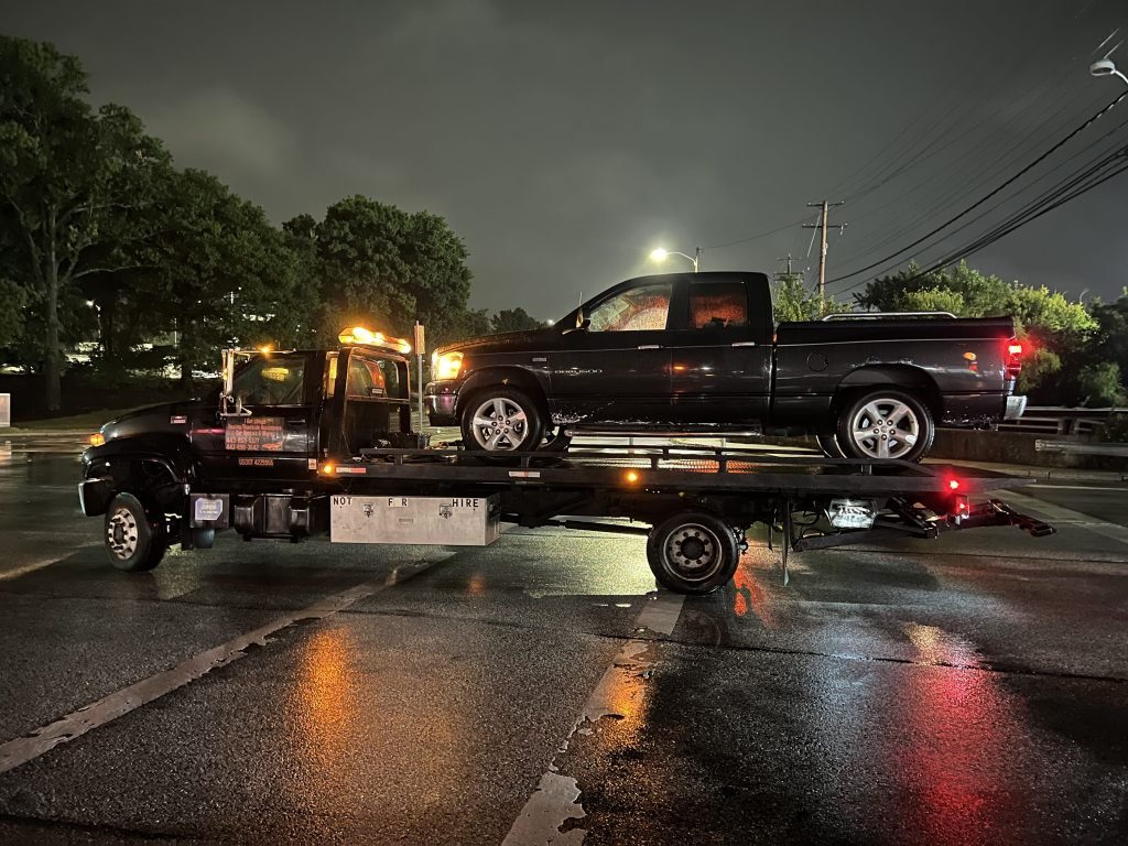 I Got Whipz Towing & Roadside Assistance with a black dodge ram 1500 truck towing near me from 6600 Security Blvd Woodlawn, MD 21207 to 2000 Summit Ave Woodlawn, MD 21207