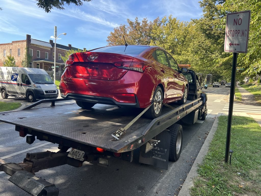 I Got Whipz Towing & Roadside Assistance with a red hyundai accent sedan towing near me from 3201 Gwynns Falls Pkwy, Baltimore, MD 21216 to 1009 Leslie Ave, Catonsville, MD 21228