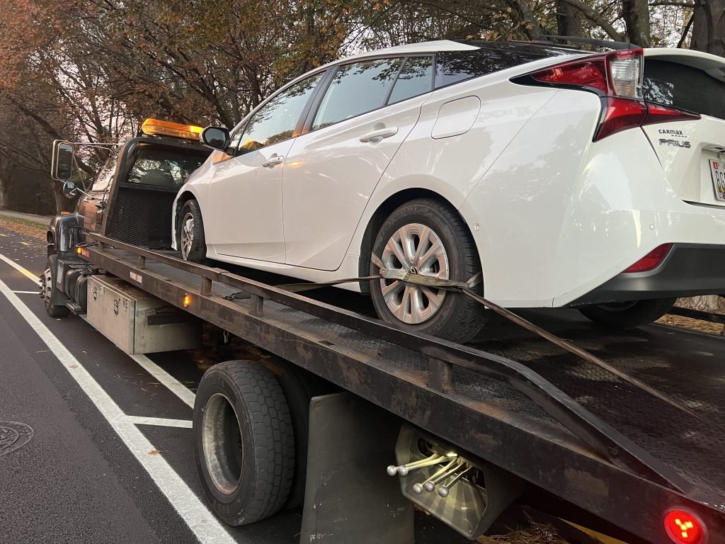 I Got Whipz Towing & Roadside Assistance with a white toyota prius towing near me from 2405 Green Summit Rd, Baltimore, MD 21209 to 5727 Reisterstown Rd, Baltimore, MD 21215