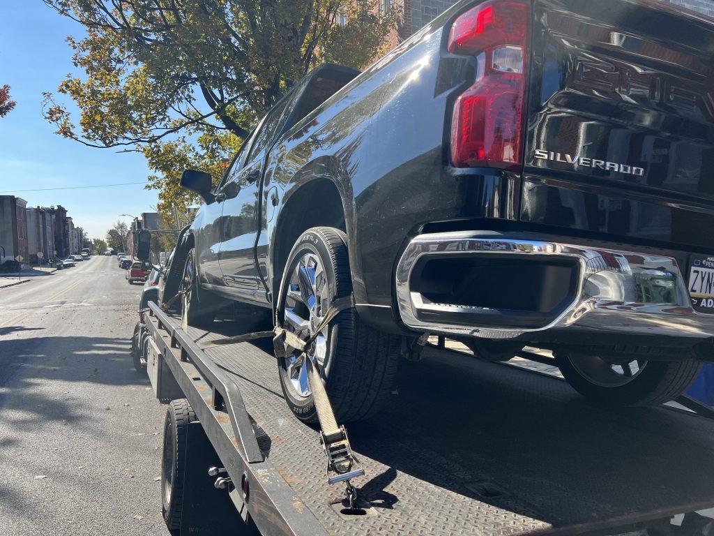 I Got Whipz Towing & Roadside Assistance with a blk chevy silverado truck towing near me from 1198 N Carey St, Baltimore, MD 21217 to 1 Kane St, Baltimore, MD 21224