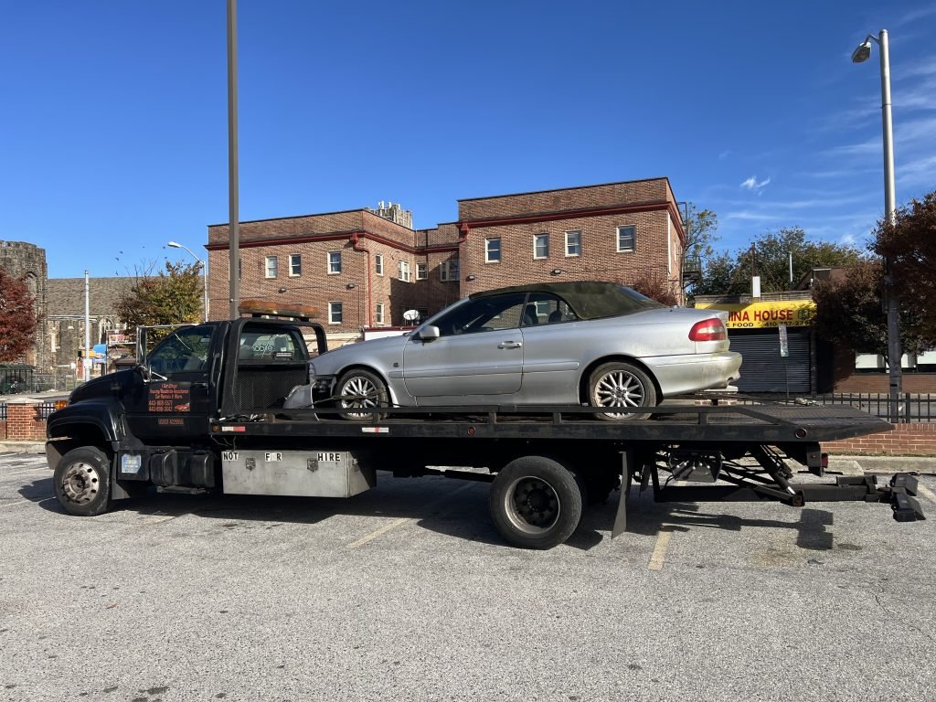 I Got Whipz Towing & Roadside Assistance with a grey volvo convertible towing near me from 1 N Monastery Ave, Baltimore, MD 21229 to 4725 Erdman Ave, Baltimore, MD 21205