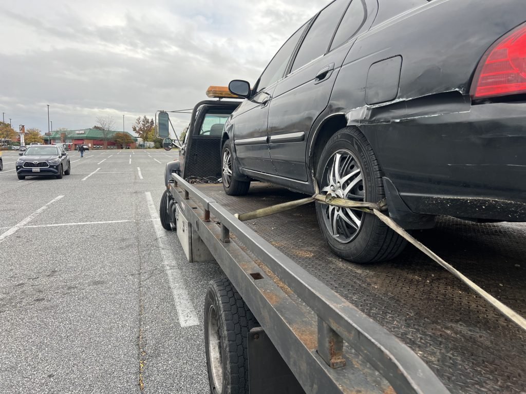 I Got Whipz Towing & Roadside Assistance with a blk nissan sentra towing near me from 7175 Security Blvd, Baltimore, MD 21244 to 3032 St Paul St, Baltimore, MD 21218