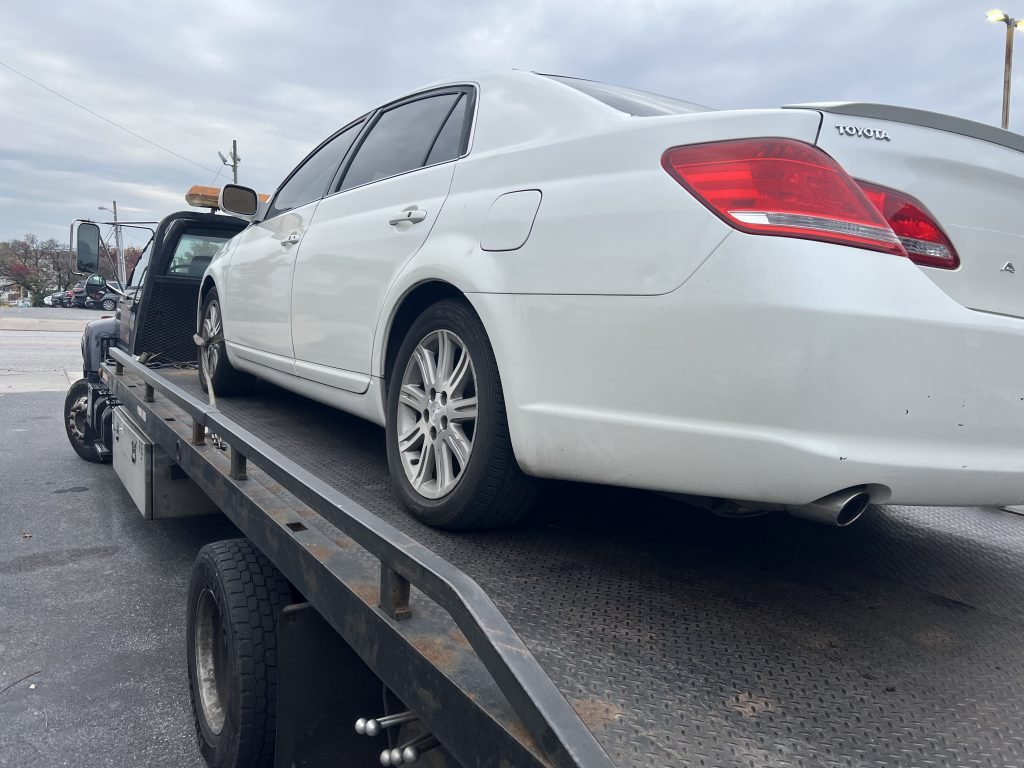 I Got Whipz Towing & Roadside Assistance with a white toyota avalon sedan towing near me from 3300 Belair Rd, Baltimore, MD 21213 to 6581 Eastern Ave, Baltimore, MD 21224