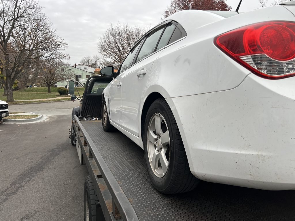 I Got Whipz Towing & Roadside Assistance with a white chevy cruze sedan towing near me from 5500 Winton Ave, Baltimore, MD 21207 to 6633 Security Blvd, Woodlawn, MD 21207