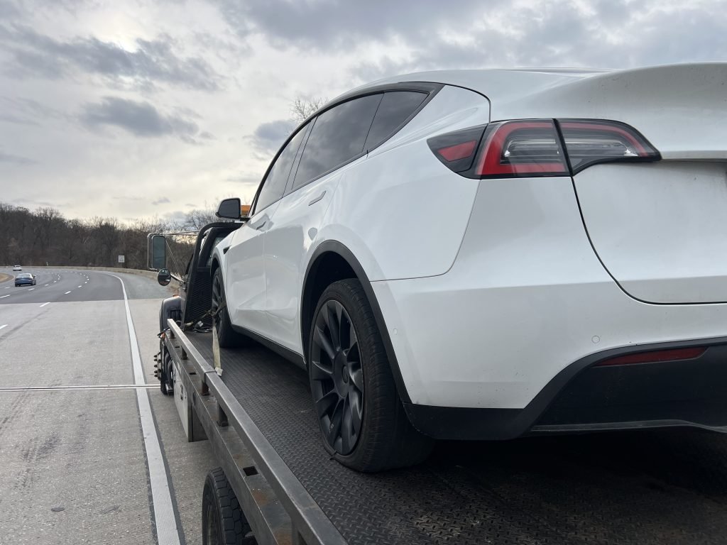 I Got Whipz Towing & Roadside Assistance with a white tesla sedan towing near me from 39.39754.-76.66579 to 9428 Reisterstown Rd, Owings Mills, MD 21117