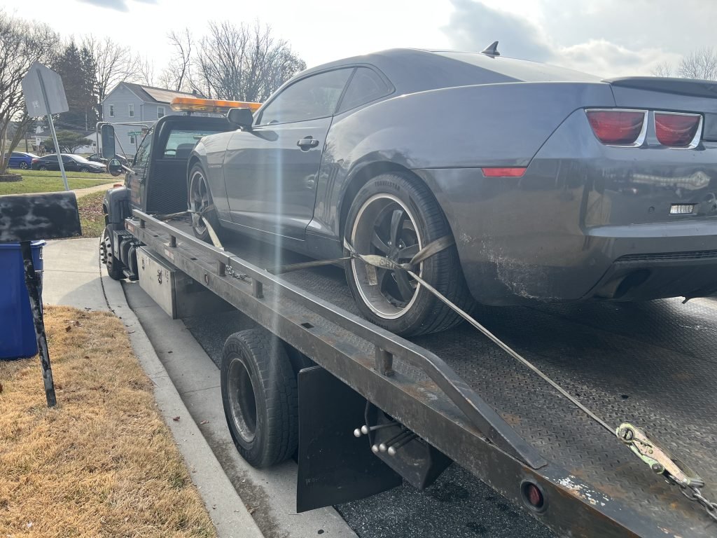 I Got Whipz Towing & Roadside Assistance with a grey Chevy Camaro coupe towing near me from 7140 Bexhill Rd Windsor Mill, MD 21244 to 1405B Merritt Blvd, Dundalk, MD 21222