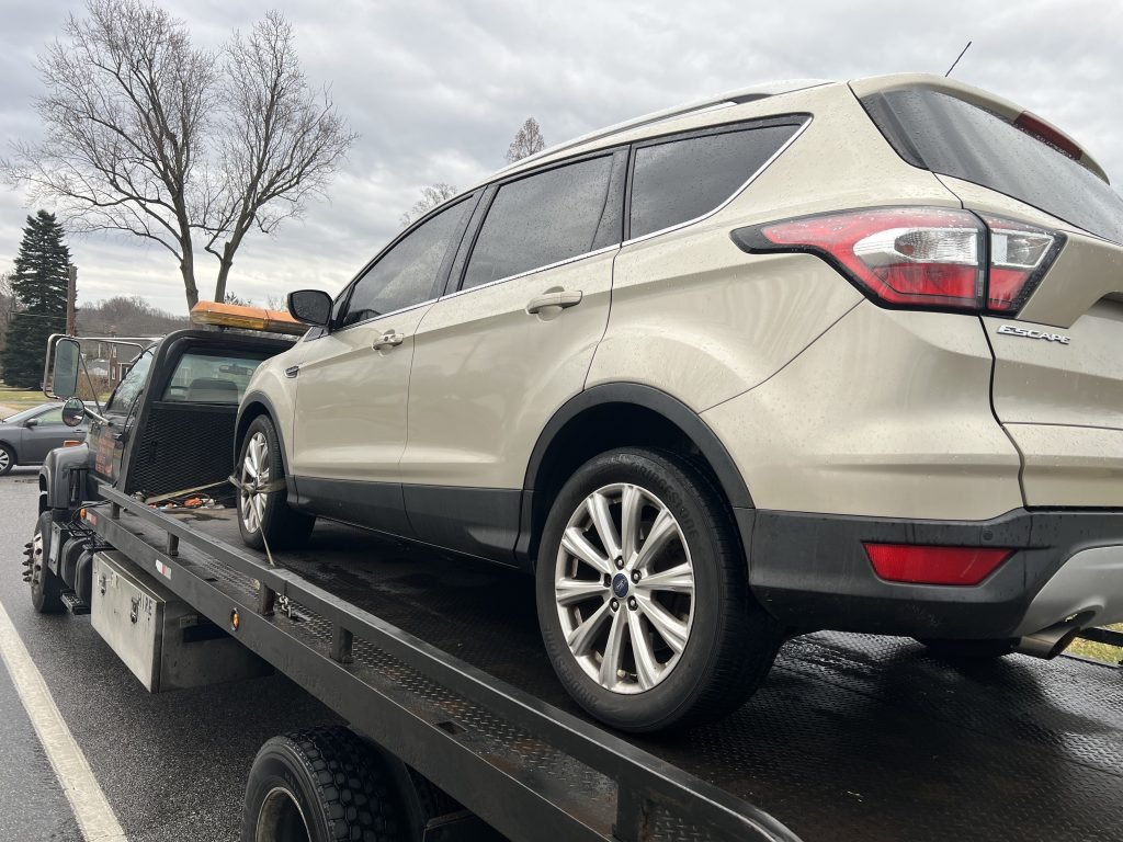 I Got Whipz Towing & Roadside Assistance with a gold ford escape suv towing near me from 2113 Edmondson Ave Baltimore, MD 21228 to 6405 Baltimore National Pike Catonsville, MD 21228